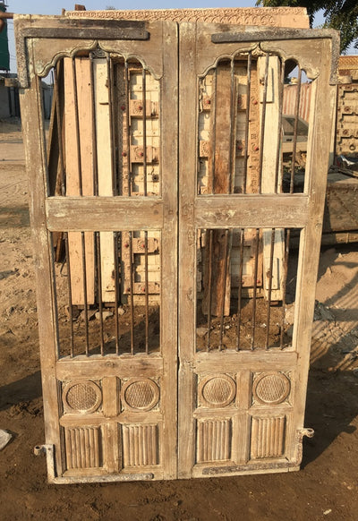 Wood Doors with Metal and Carved Accents